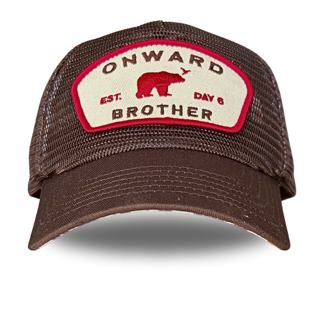 A brown mesh-back trucker cap with a curved brim, featuring a cream-colored front patch with a red border, a red bear graphic, and the text 'ONWARD BROTHER' and 'EST. DAY 6'.